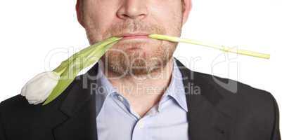 Man holding tulip in his mouth
