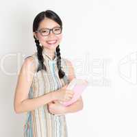 Asian Chinese school girl hands holding text books