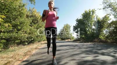 Woman fitness jogging workout on countryside road