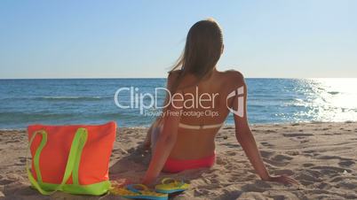 Bikini woman with colorful accessories enjoying summer beach vacation