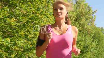 Fit sports woman running at park during outdoor workout