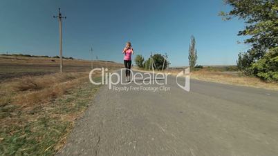 Young female athlete runner jogging during outdoor workout