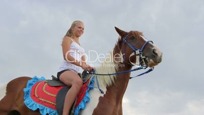 Young girl in the saddle on horse