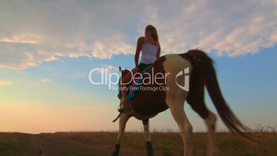 Horseback riding to the horizon at sunset