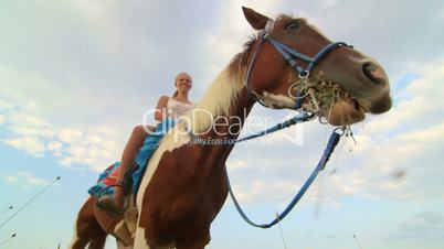 Horseback riding vacations girl rider with her horse in the field