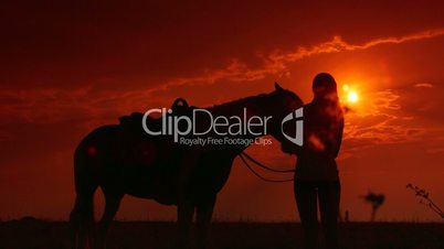 Horseback riding silhouette at sunset