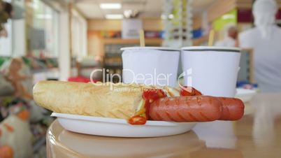 Customers ordered fast-food snack hot dogs and drinks in convenience store