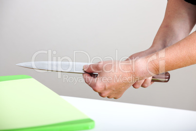 Hands holding a kitchen knife