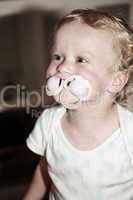 Toddler with two pacifier in her mouth
