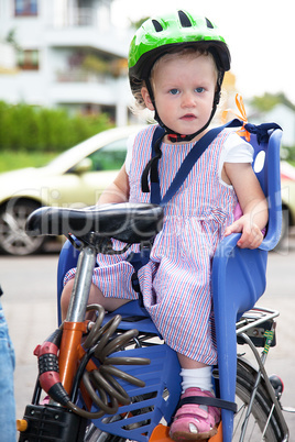 Child sits strapped in the seat bicycle