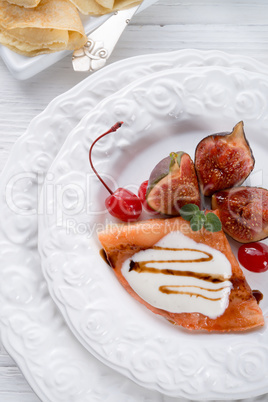 flambe pancakes with figs and cherries.