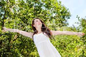 Woman with zest for life has arms outstretched
