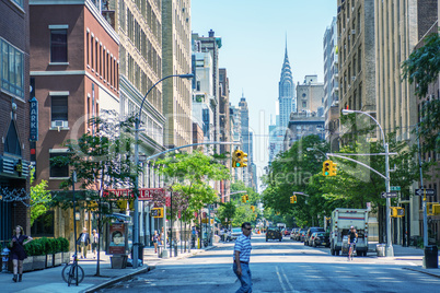 NEW YORK CITY - JUNE 15, 2013: Tourists walk along city streets.