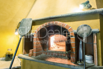 Interior of kitchen with an oven and a burning fire