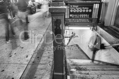 New York City. Subway entrance and stairs at night with moving p