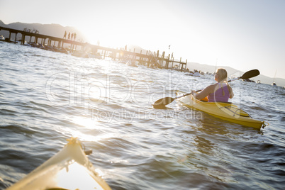 Woman Kayaking on Beautiful Mountain Lake.