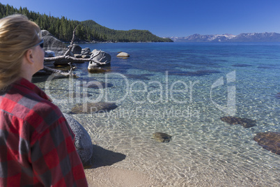 Woman Looking Over Beautiful Shoreline of Lake Tahoe.