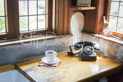 Antique Phone and Cup of Coffee in Old Kitchen Setting