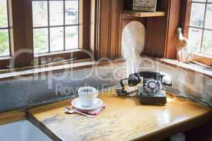 Antique Phone and Cup of Coffee in Old Kitchen Setting
