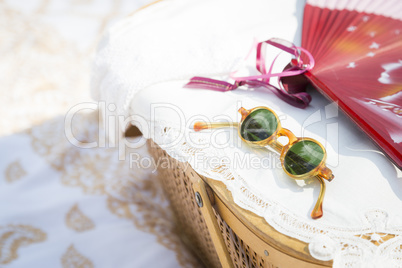 Sunglasses, Chinese Fan and Picnic Basket on Blanket