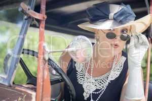 Attractive Woman in Twenties Outfit Checking Makeup in Antique A