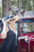 Attractive Woman in Twenties Outfit Near Antique Automobile