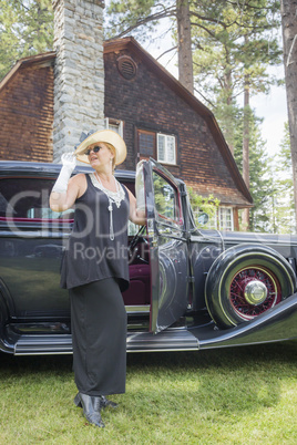 Attractive Woman in Twenties Outfit Near Antique Automobile