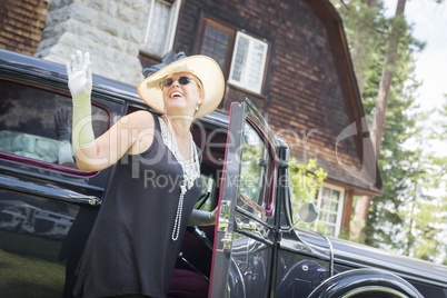 Attractive Woman in Twenties Outfit Near Antique Automobile