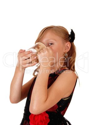 Girl drinking from a mug.