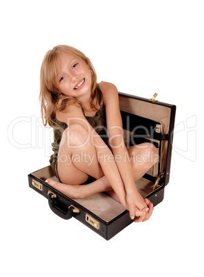 Girl sitting in briefcase.