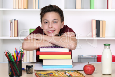 Junge und ein Stapel Bücher in der Schule