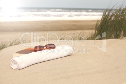 Book sunglasses  towel on a beach