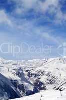 Snowy mountains and ski slope at nice day