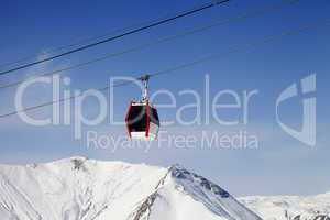 Gondola lift and snowy mountains