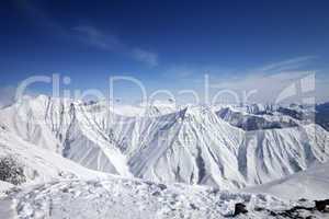 Winter snowy mountains and blue sky