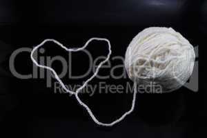 Heart and a ball of white thread