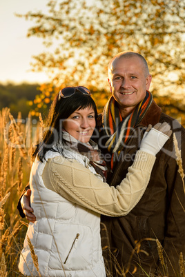 Romantic couple hugging autumn sunset countryside