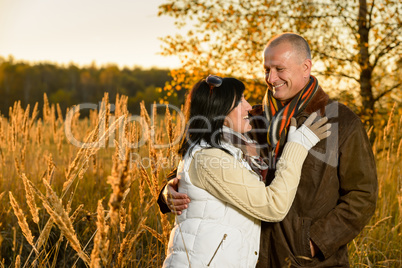 Couple in love hugging in autumn sunset