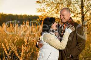 Couple in love hugging in autumn sunset