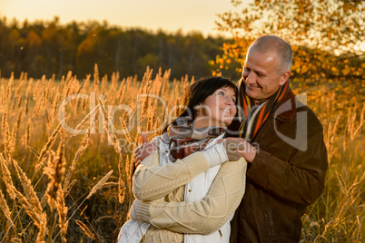 Couple in love embracing in autumn sunset