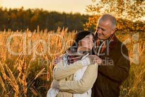 Couple in love embracing in autumn sunset