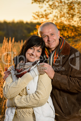 Romantic couple embracing in autumn sunset park