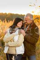 Couple in love hugging in autumn countryside