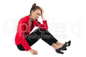 Thinking businesswoman sitting on the floor