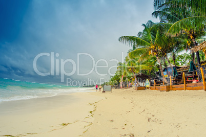 Caribbean beach on a overcast day. Thunderstorm approaching the