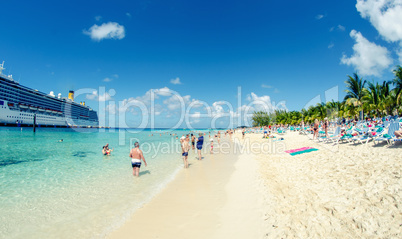 Beach with turquoise waters and cruise ship on a beautiful day