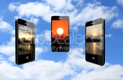 three mobile phones with different sunsets