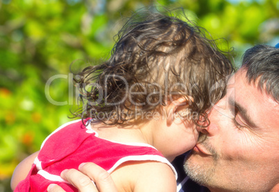 Father sweet kiss to his daughter