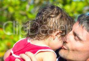 Father sweet kiss to his daughter