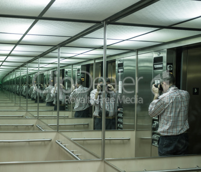 Photographing the mirror. Multiple man reflections